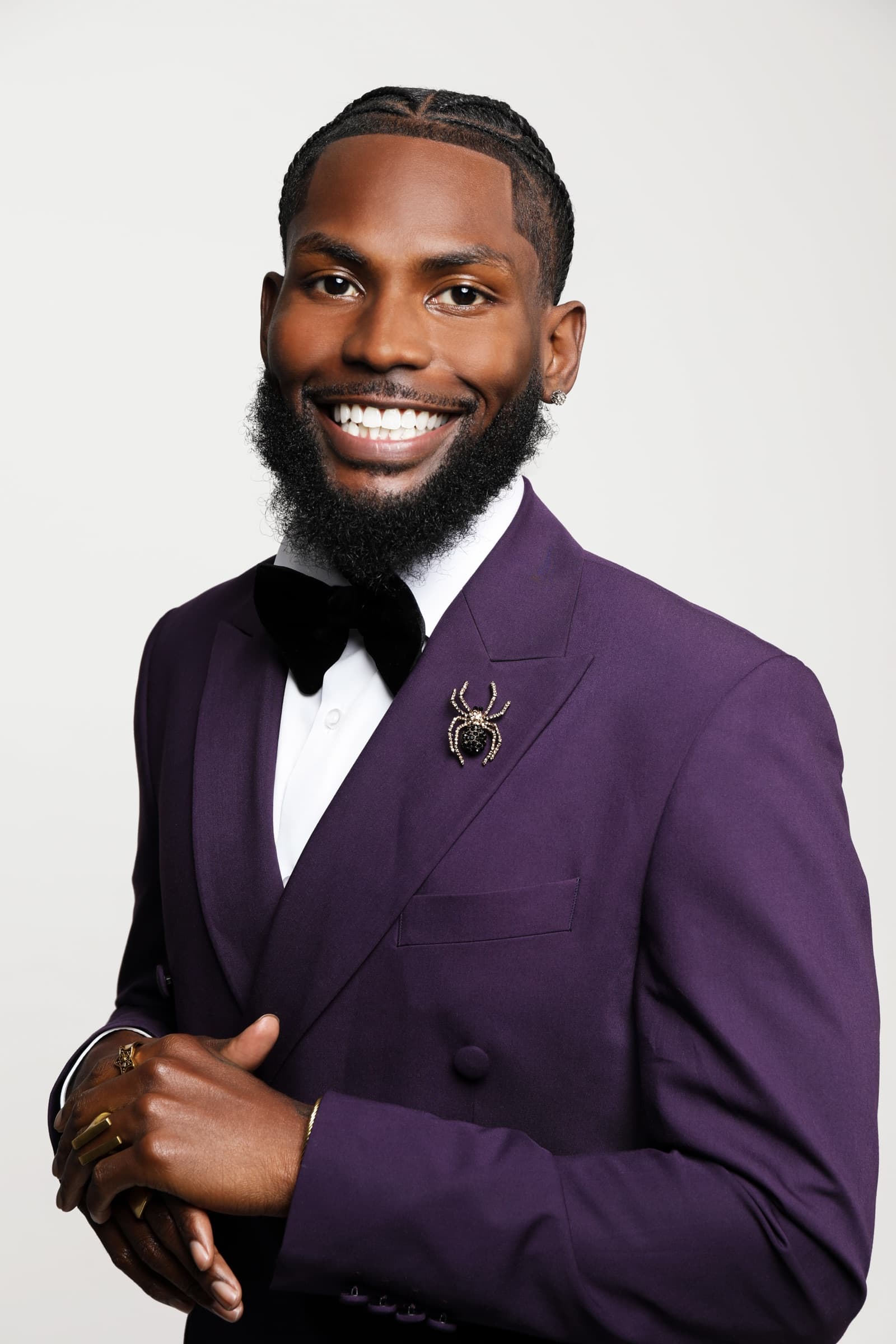 Studio portrait of Sly Huncho in a purple suit